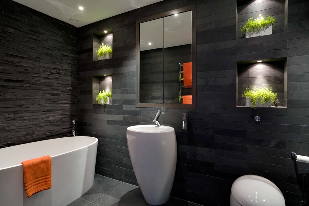 Bathroom - mid-sized contemporary kids' slate tile and gray tile slate floor and gray floor bathroom idea in London with a pedestal sink, recessed-panel cabinets, dark wood cabinets, a wall-mount toilet, gray walls and a niche