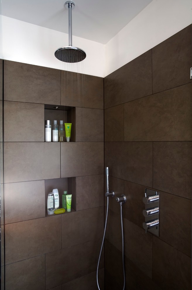 This is an example of a medium sized contemporary ensuite bathroom in London with a walk-in shower, brown tiles, ceramic tiles, brown walls, ceramic flooring, brown floors and an open shower.
