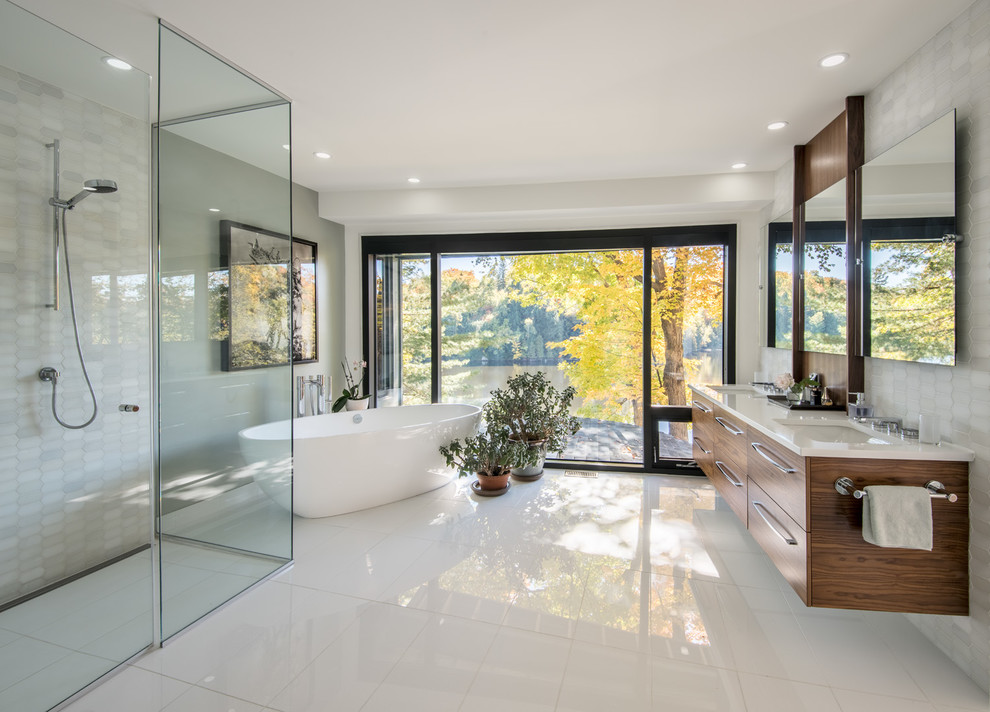 Example of a trendy master white tile white floor bathroom design in Ottawa with flat-panel cabinets, medium tone wood cabinets, gray walls, an undermount sink and a hinged shower door