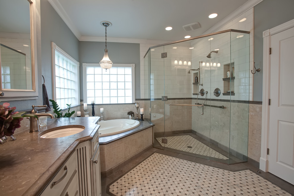 Bathroom - large traditional master beige tile and stone tile mosaic tile floor bathroom idea in Other with an undermount sink, raised-panel cabinets, distressed cabinets, limestone countertops, a two-piece toilet and blue walls