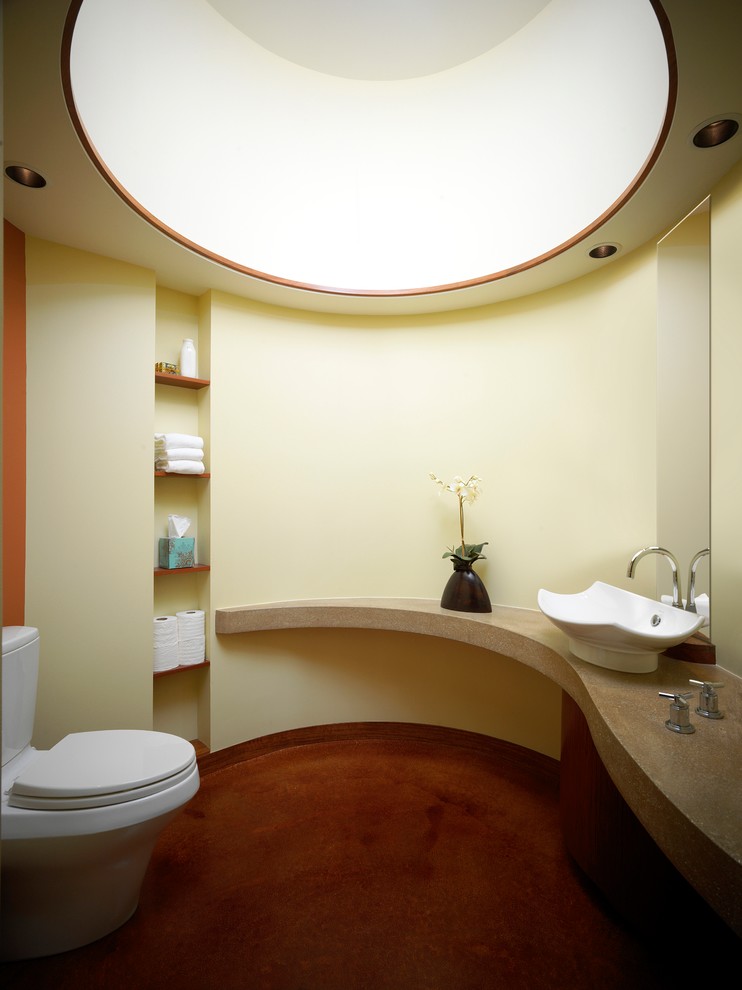 Example of a trendy bathroom design in Milwaukee with a two-piece toilet, beige walls, a vessel sink and open cabinets