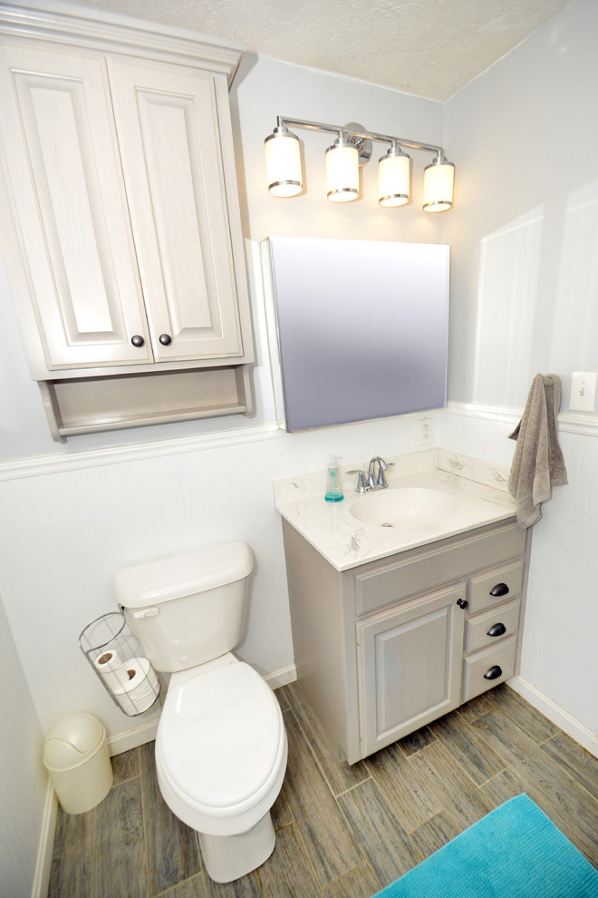 Cette image montre une salle de bain principale rustique en bois clair avec un placard avec porte à panneau surélevé, une baignoire en alcôve, un combiné douche/baignoire, WC séparés, un carrelage blanc, mosaïque, un mur blanc, un plan vasque, un plan de toilette en marbre et un sol en carrelage de céramique.