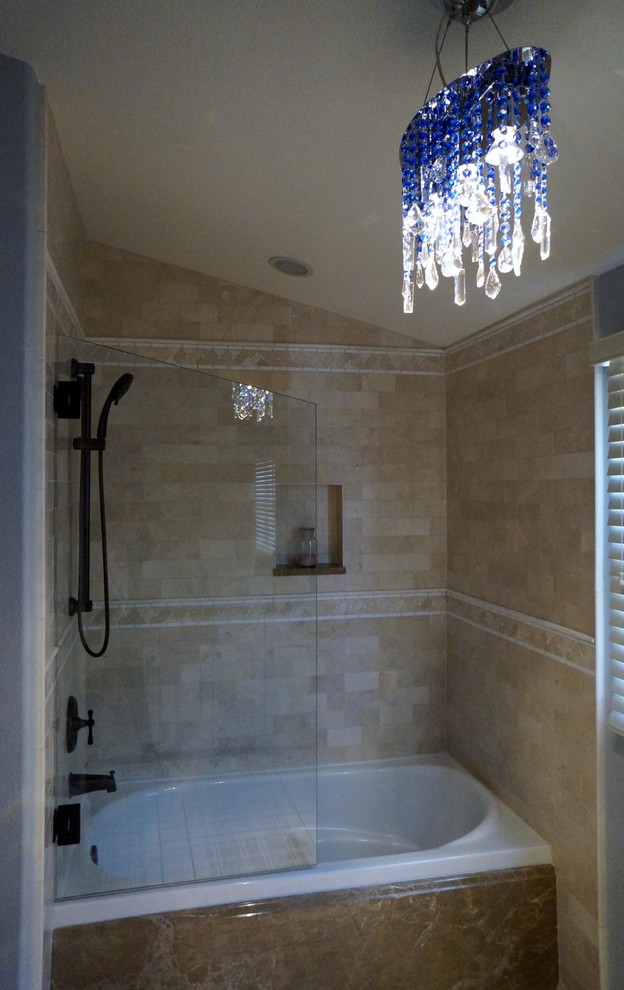 This is an example of a medium sized traditional ensuite bathroom in Denver with an alcove bath, a shower/bath combination, beige tiles, ceramic tiles, a built-in sink and blue walls.