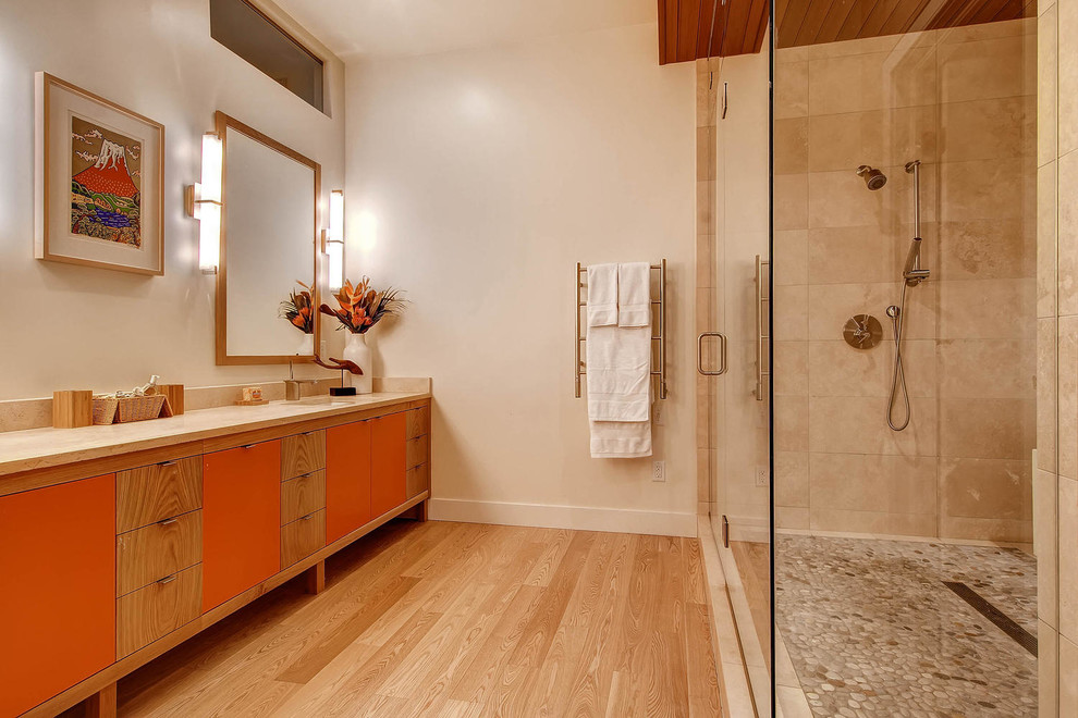 デンバーにあるコンテンポラリースタイルのおしゃれな浴室 (アンダーカウンター洗面器、フラットパネル扉のキャビネット、オレンジのキャビネット、ベージュのタイル、ベージュの壁、淡色無垢フローリング) の写真