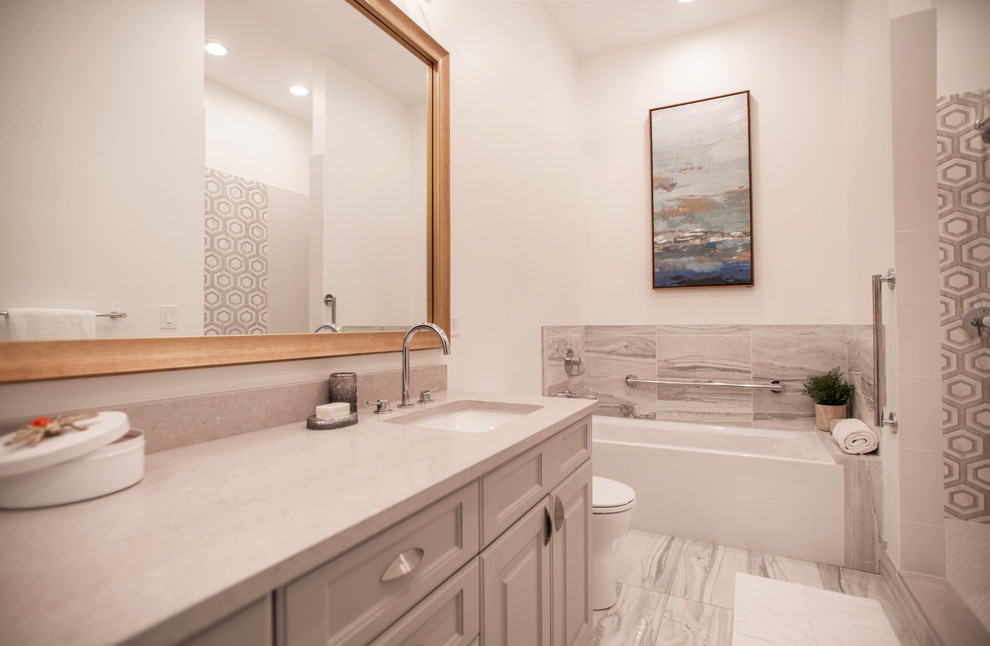Inspiration for a mid-sized contemporary master wet room remodel in Denver with shaker cabinets, beige cabinets, a one-piece toilet, beige walls, an undermount sink, quartz countertops and a hinged shower door