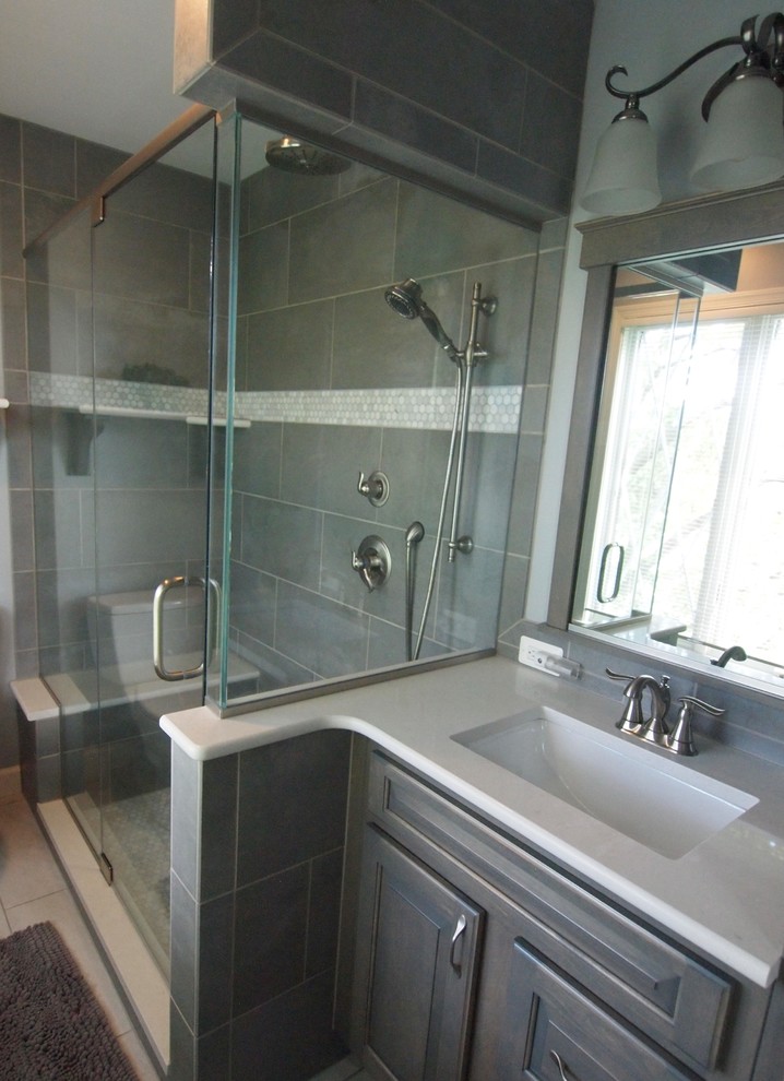 Small elegant master gray tile and ceramic tile ceramic tile and white floor alcove shower photo in Baltimore with raised-panel cabinets, gray cabinets, a two-piece toilet, gray walls, an undermount sink, quartzite countertops and a hinged shower door