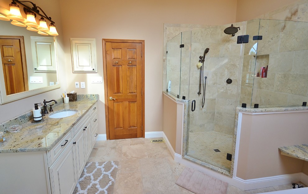 Inspiration for a large timeless master beige tile and ceramic tile ceramic tile bathroom remodel in Philadelphia with recessed-panel cabinets, white cabinets, a one-piece toilet, beige walls, an undermount sink and granite countertops