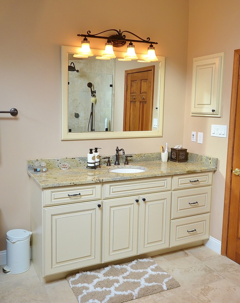 Example of a large classic master beige tile and ceramic tile ceramic tile bathroom design in Philadelphia with recessed-panel cabinets, white cabinets, a one-piece toilet, beige walls, an undermount sink and granite countertops