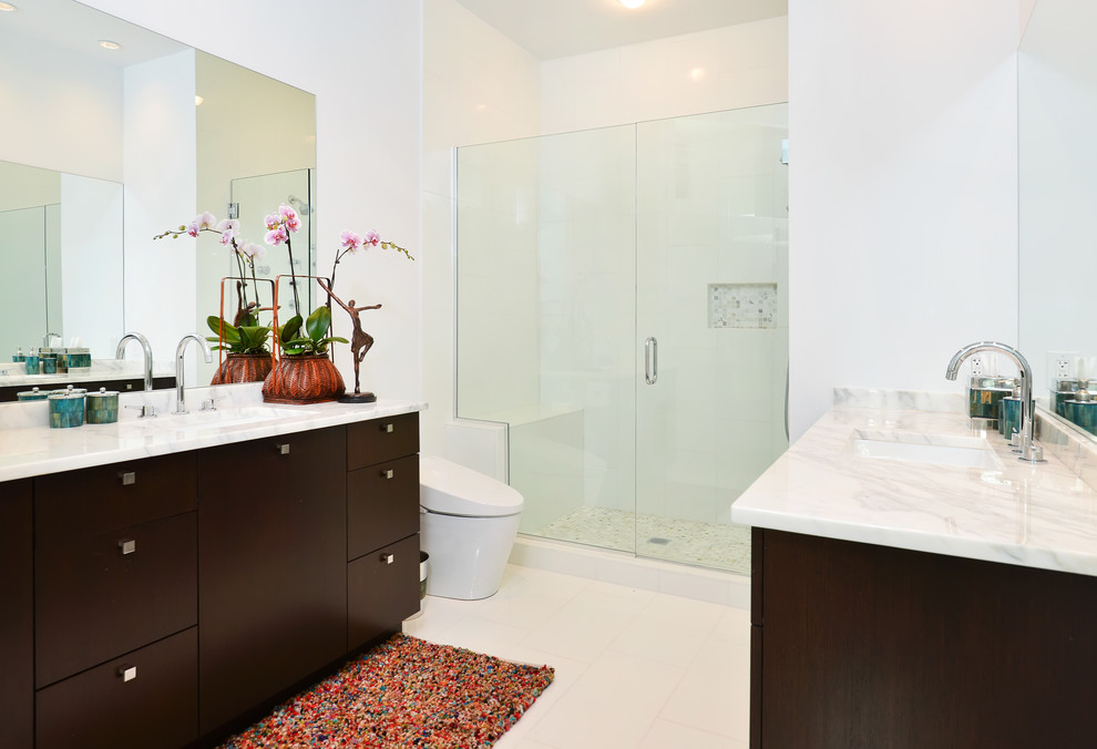 Design ideas for a large contemporary ensuite bathroom in Chicago with a submerged sink, flat-panel cabinets, dark wood cabinets, marble worktops, an alcove shower, a one-piece toilet, white tiles, porcelain tiles, white walls and porcelain flooring.