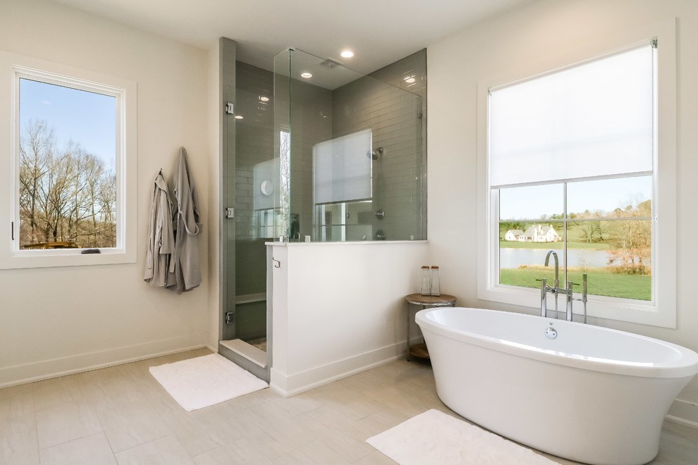 Large minimalist master gray tile and glass tile ceramic tile and white floor bathroom photo in Jackson with shaker cabinets, white cabinets, a one-piece toilet, white walls, a drop-in sink, quartzite countertops and a hinged shower door