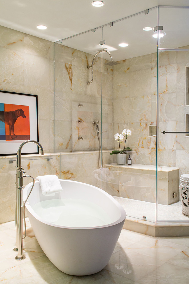 Photo of a contemporary bathroom in Boston with a freestanding bath and stone tiles.