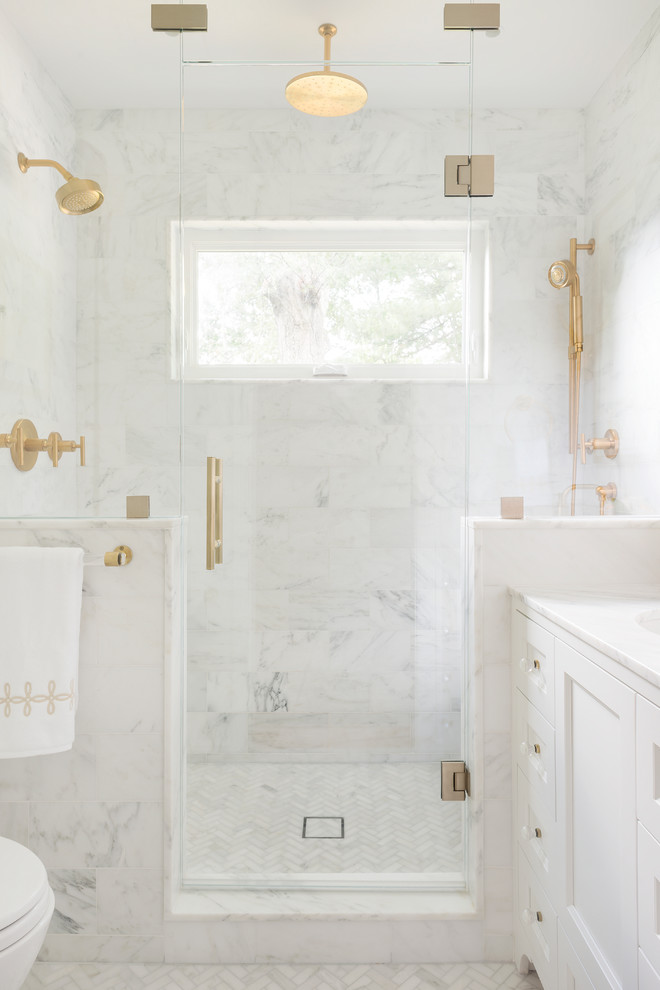 Small transitional master white tile and stone tile mosaic tile floor and white floor alcove shower photo in Boston with shaker cabinets, a wall-mount toilet, white walls, an undermount sink, marble countertops, white cabinets and a hinged shower door