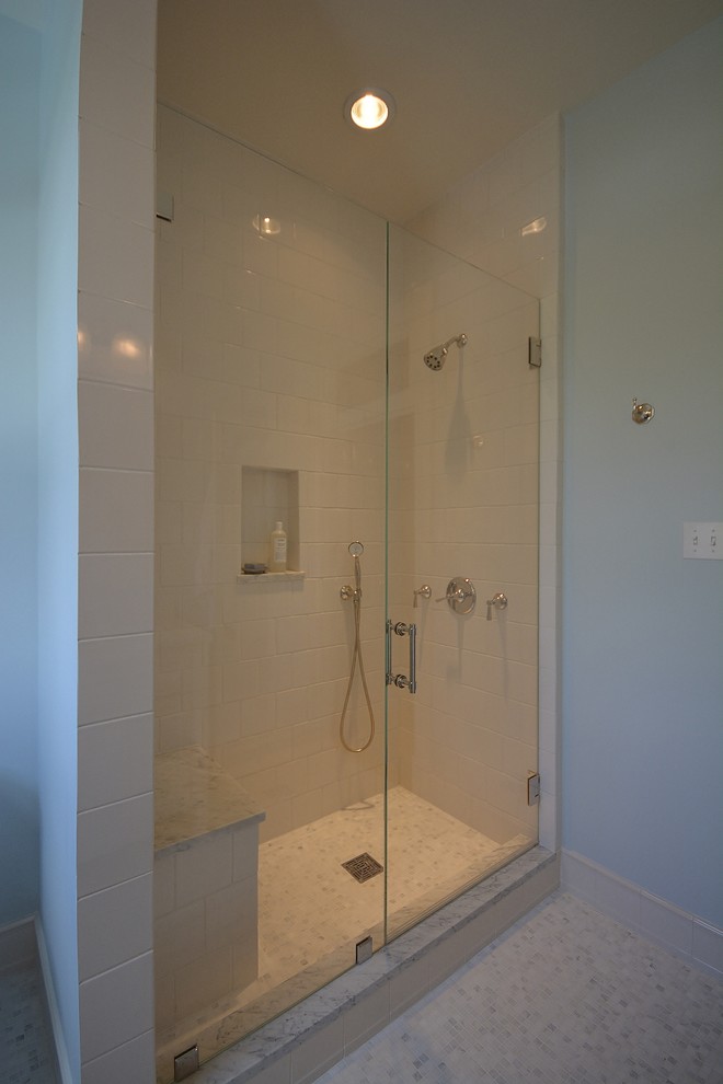 Mid-sized minimalist 3/4 white tile and stone slab marble floor bathroom photo in DC Metro with an undermount sink, furniture-like cabinets, white cabinets, quartzite countertops, a two-piece toilet and blue walls
