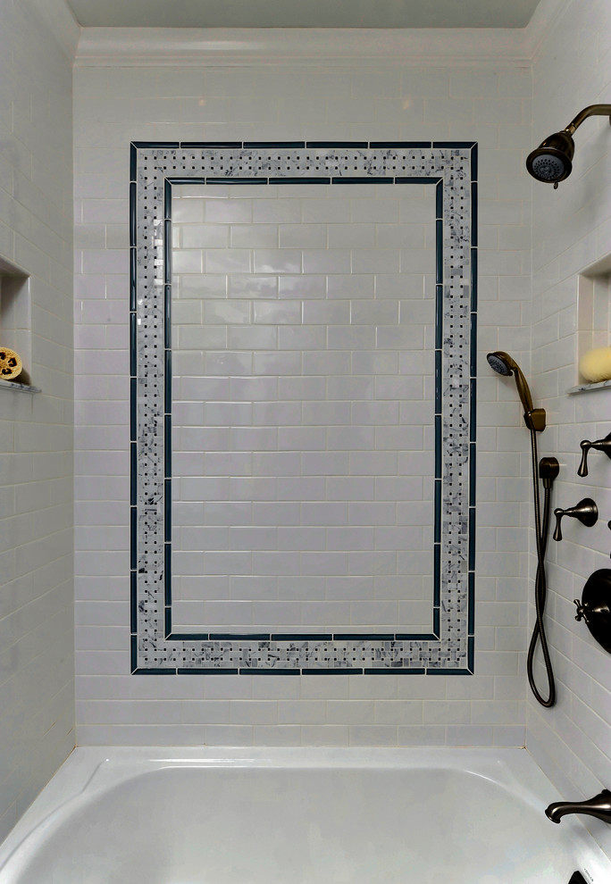 Photo of a medium sized traditional ensuite bathroom in DC Metro with recessed-panel cabinets, brown cabinets, a submerged bath, a shower/bath combination, a two-piece toilet, white tiles, metro tiles, green walls, mosaic tile flooring, a submerged sink, marble worktops, white floors and a shower curtain.