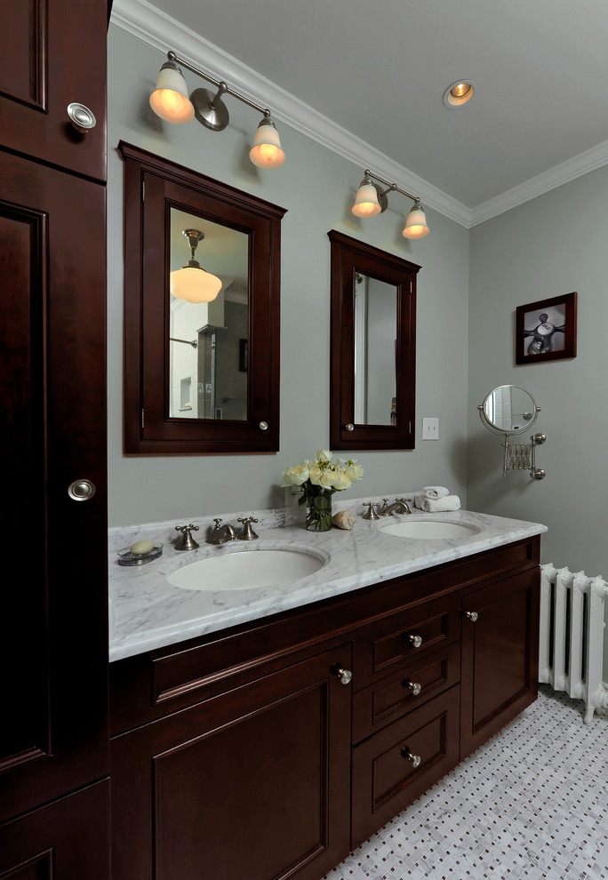 Example of a mid-sized classic master white tile and subway tile mosaic tile floor and white floor bathroom design in DC Metro with recessed-panel cabinets, brown cabinets, an undermount tub, a two-piece toilet, green walls, an undermount sink and marble countertops