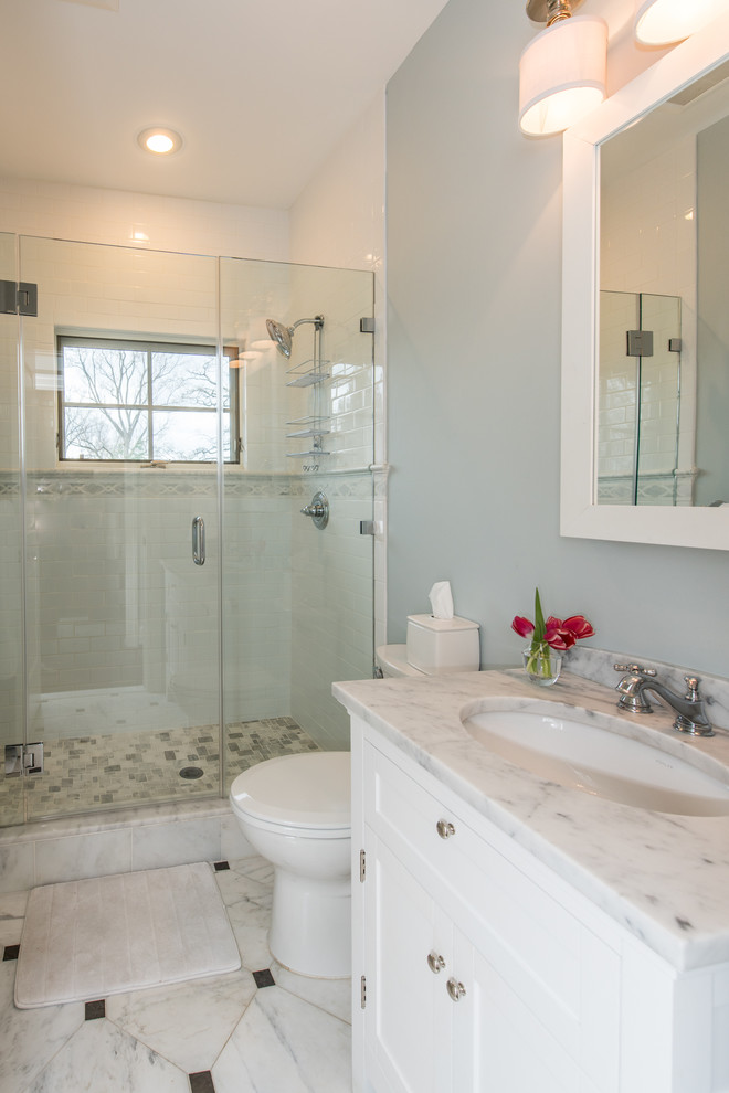 Design ideas for a medium sized contemporary family bathroom in DC Metro with recessed-panel cabinets, white cabinets, an alcove shower, a two-piece toilet, black and white tiles, stone tiles, blue walls, marble flooring, a submerged sink and granite worktops.