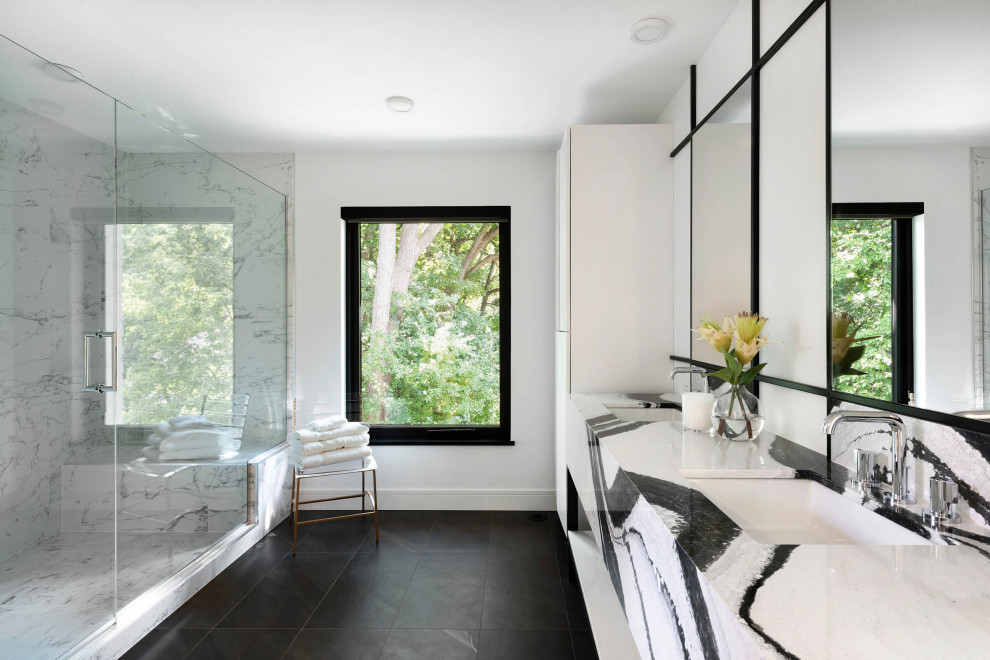 This is an example of a medium sized traditional ensuite wet room bathroom in Minneapolis with white cabinets, white tiles, white walls, marble worktops, black floors, a hinged door and white worktops.