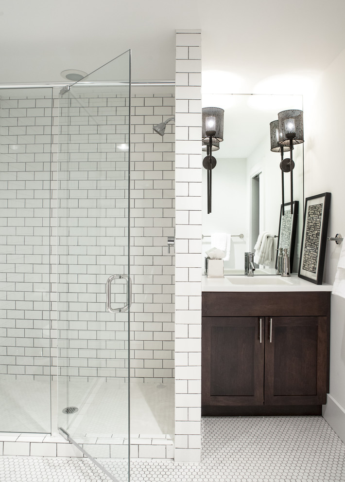 Photo of a large classic shower room bathroom in St Louis with white walls, shaker cabinets, dark wood cabinets, an alcove shower, white tiles, white floors, metro tiles, mosaic tile flooring, a submerged sink, engineered stone worktops, a hinged door, white worktops and feature lighting.