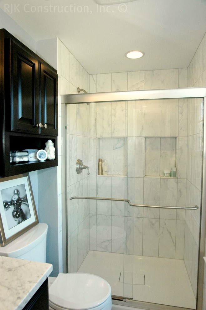 Inspiration for a mid-sized transitional 3/4 white tile and porcelain tile porcelain tile alcove shower remodel in DC Metro with an undermount sink, raised-panel cabinets, dark wood cabinets, marble countertops, a two-piece toilet and gray walls