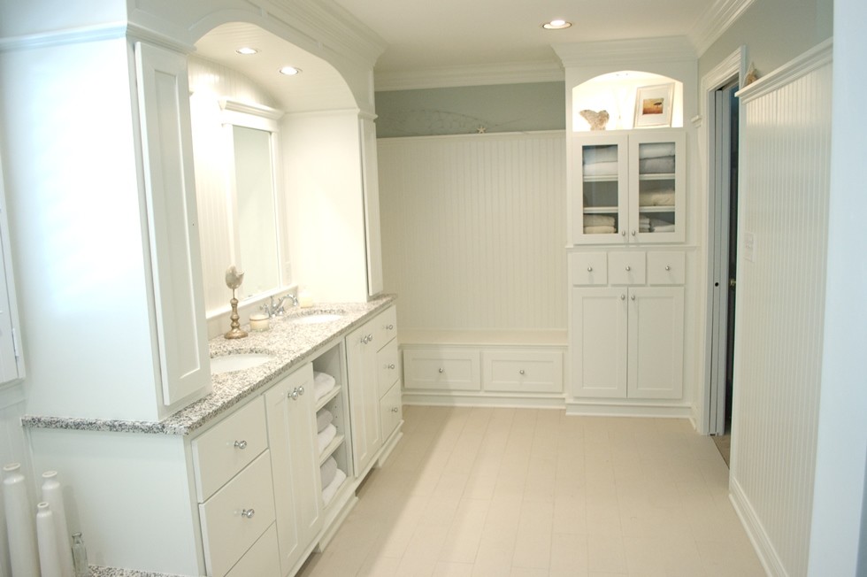 Inspiration for a large coastal bathroom in Indianapolis with a built-in bath, flat-panel cabinets, white cabinets, blue walls, ceramic flooring, a submerged sink and granite worktops.
