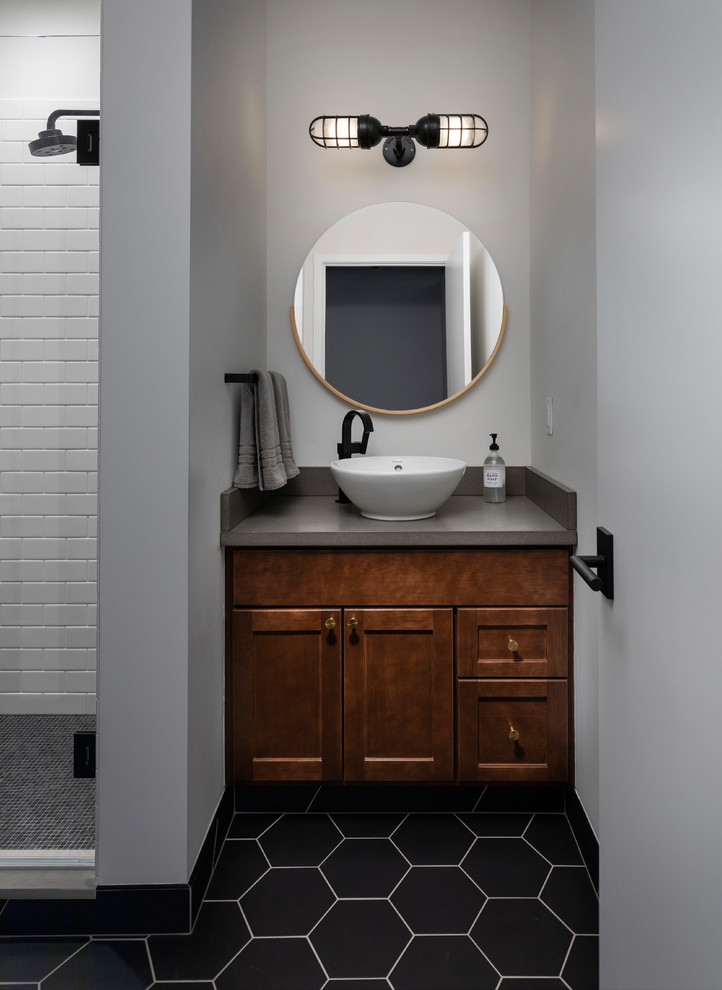Alcove shower - mid-sized eclectic 3/4 white tile and subway tile ceramic tile and black floor alcove shower idea in Detroit with recessed-panel cabinets, medium tone wood cabinets, a two-piece toilet, white walls, a vessel sink, a hinged shower door, gray countertops and concrete countertops