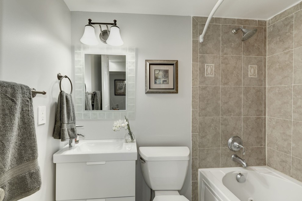 Small trendy 3/4 brown tile and ceramic tile bathroom photo in DC Metro with flat-panel cabinets, white cabinets, a one-piece toilet, gray walls, an integrated sink and quartzite countertops