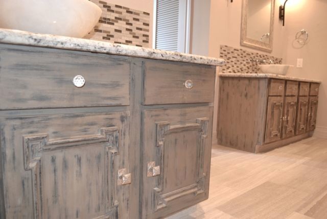 Inspiration for a large classic ensuite bathroom in Houston with freestanding cabinets, distressed cabinets, a claw-foot bath, a two-piece toilet, grey tiles, grey walls, marble flooring, a corner shower, stone tiles, a vessel sink and granite worktops.