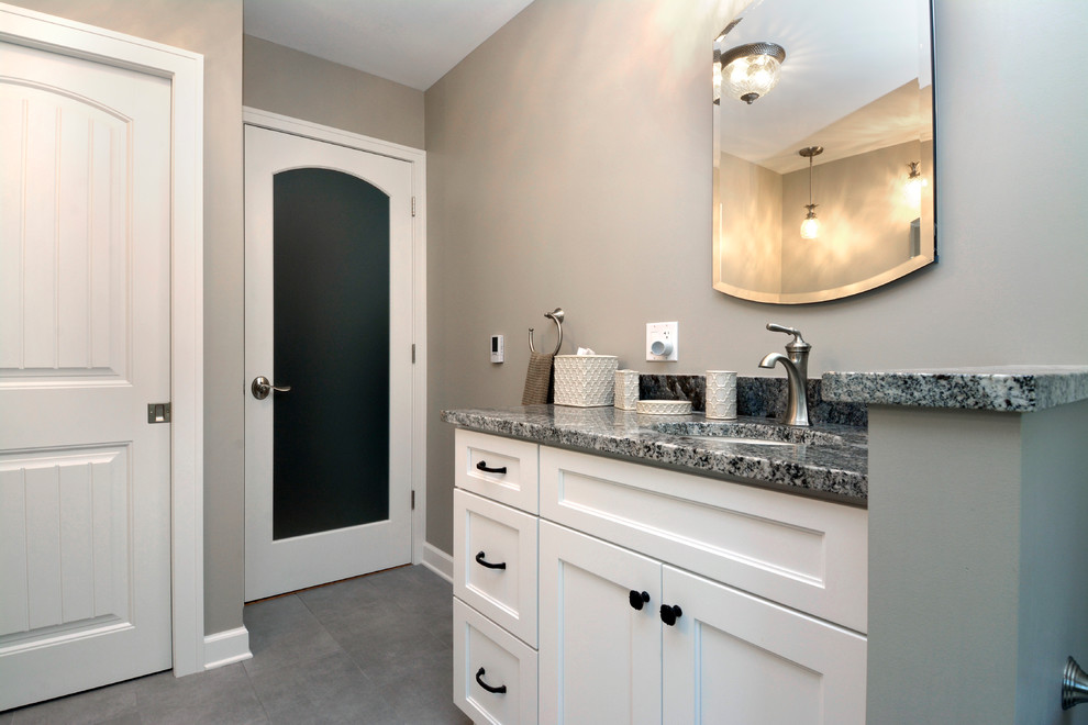 Large classic ensuite bathroom in Chicago with recessed-panel cabinets, white cabinets, an alcove shower, a two-piece toilet, grey tiles, ceramic tiles, grey walls, ceramic flooring, a submerged sink and granite worktops.