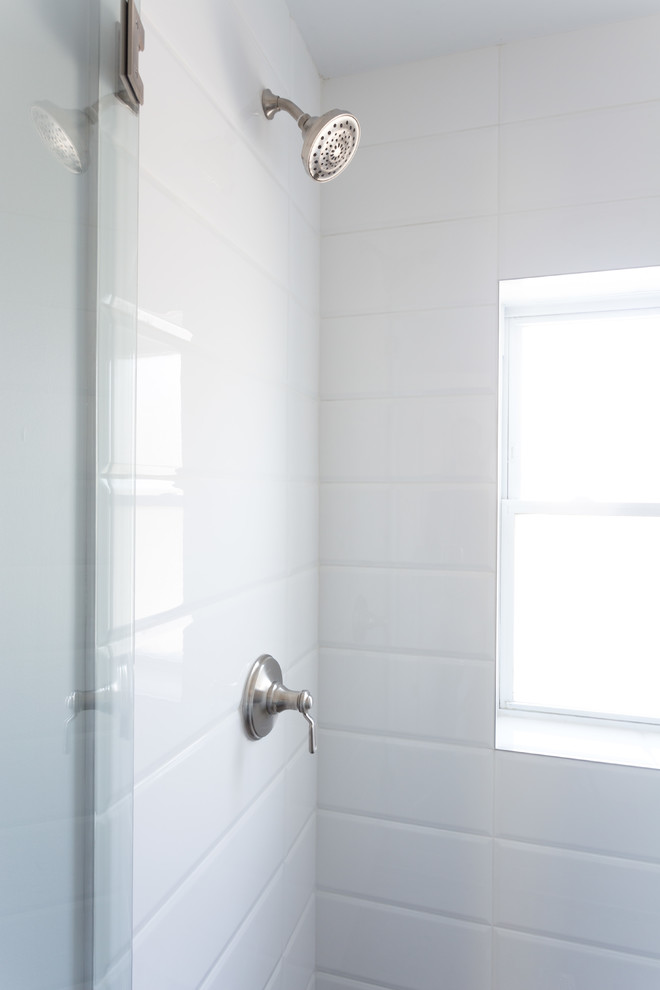 Bild på ett litet funkis badrum med dusch, med en toalettstol med hel cisternkåpa, vit kakel, tunnelbanekakel, grå väggar, klinkergolv i keramik, ett undermonterad handfat, luckor med lamellpanel, vita skåp, våtrum och bänkskiva i kalksten