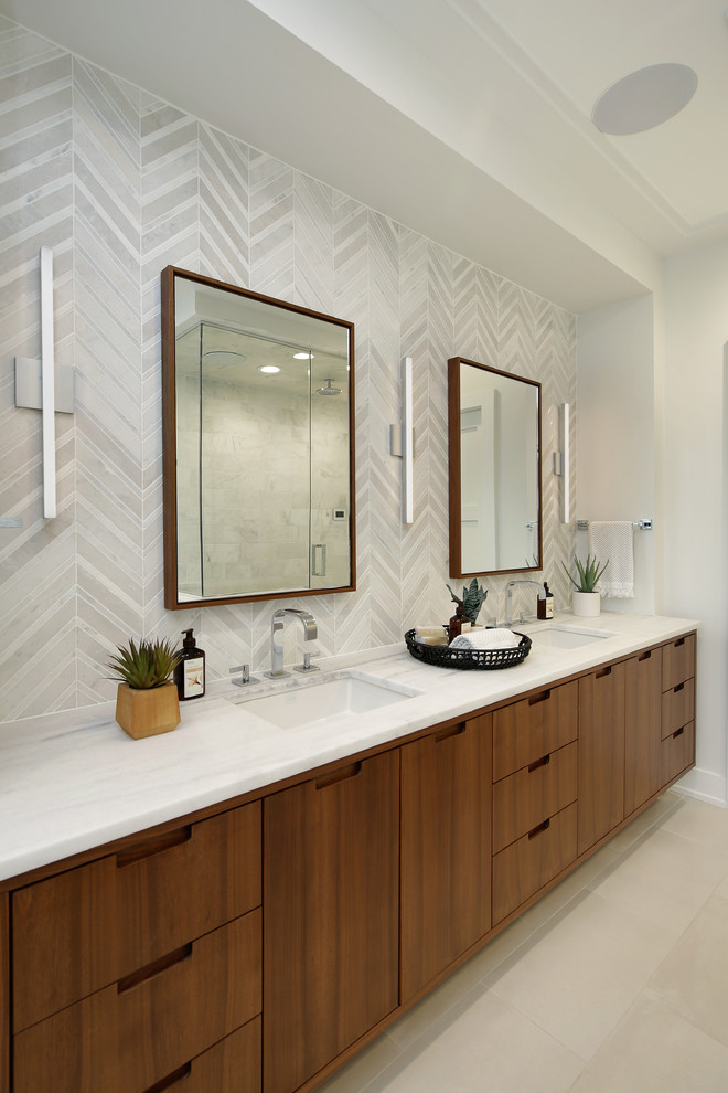 Bathroom - large modern master white tile and stone tile ceramic tile bathroom idea in Chicago with flat-panel cabinets, brown cabinets, a one-piece toilet, white walls, an undermount sink, quartzite countertops, a hinged shower door and white countertops
