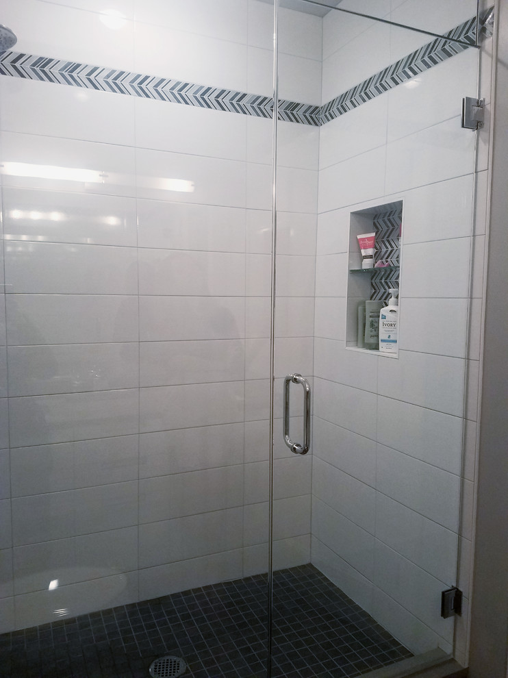 Mid-sized minimalist 3/4 white tile and ceramic tile porcelain tile and gray floor alcove shower photo in Chicago with flat-panel cabinets, white cabinets, a two-piece toilet, gray walls, an undermount sink, quartz countertops, a hinged shower door and gray countertops