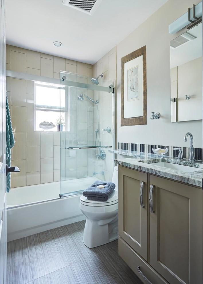 This is an example of a small traditional family bathroom in Chicago with shaker cabinets, grey cabinets, an alcove bath, a shower/bath combination, a one-piece toilet, beige tiles, ceramic tiles, beige walls, porcelain flooring, a submerged sink and quartz worktops.