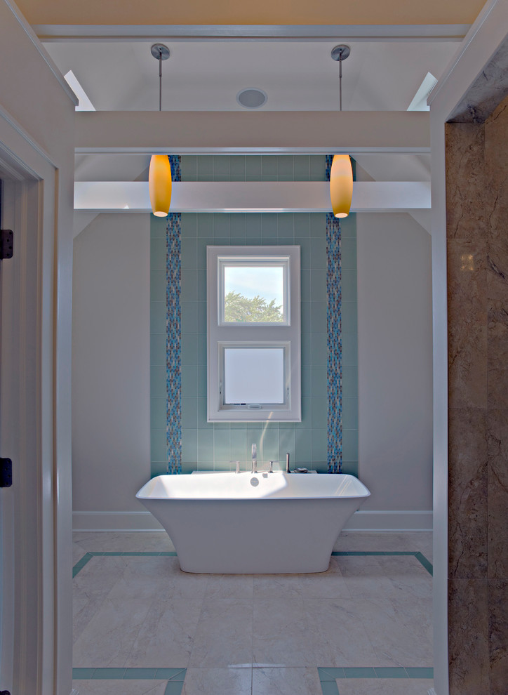 This is an example of a large traditional bathroom in Chicago with a freestanding bath, blue tiles and glass tiles.