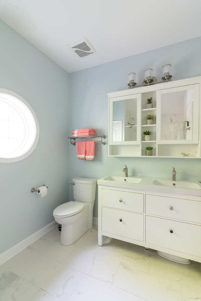 This is an example of a traditional family bathroom in Boston with flat-panel cabinets, white cabinets, an alcove bath, an alcove shower, blue walls, marble flooring, engineered stone worktops, white floors, a shower curtain and white worktops.