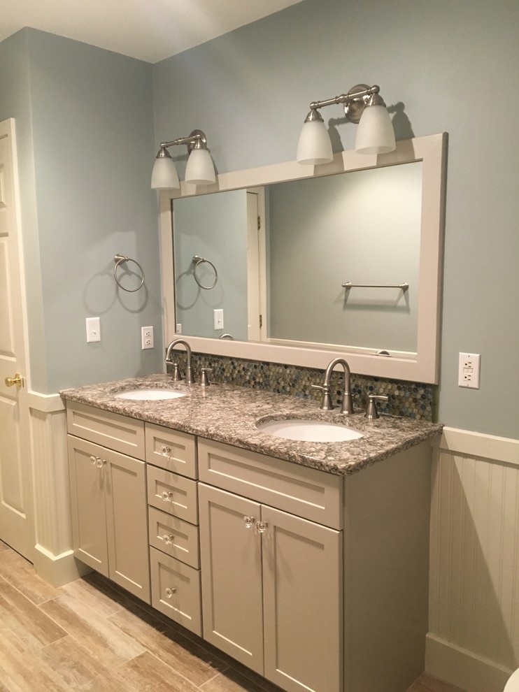 Example of a mid-sized beach style 3/4 beige tile and multicolored tile bathroom design in Other with recessed-panel cabinets, white cabinets, gray walls, an undermount sink, granite countertops and gray countertops