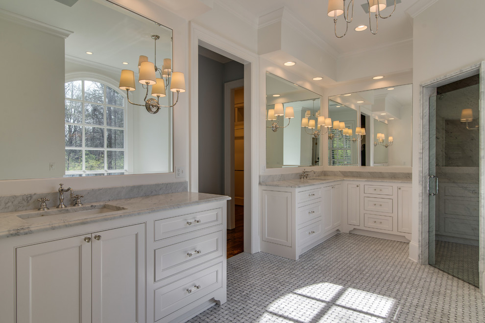 Example of a large classic master marble floor and yellow floor bathroom design in Nashville with white cabinets, white walls, an undermount sink, a hinged shower door and white countertops