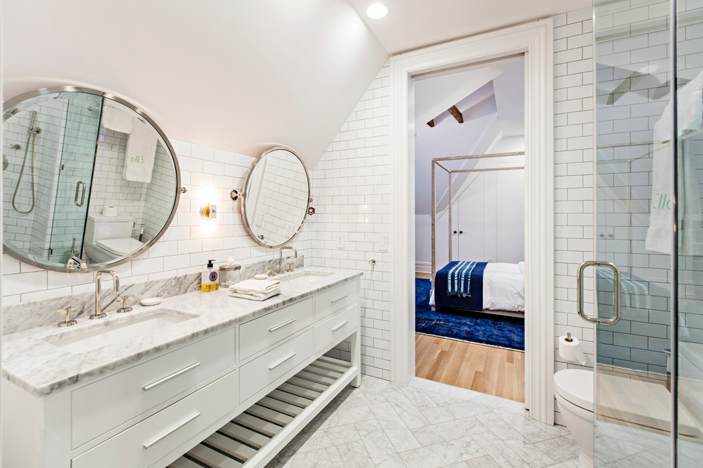 Photo of a medium sized traditional shower room bathroom in New York with freestanding cabinets, white cabinets, a corner shower, a one-piece toilet, white tiles, ceramic tiles, white walls, marble flooring, a submerged sink, marble worktops, white floors and a hinged door.
