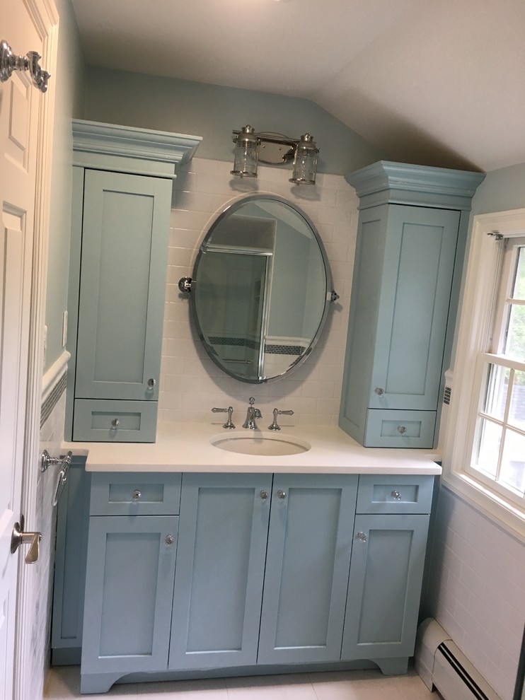 Example of a small beach style kids' white tile and subway tile porcelain tile and white floor bathroom design in New York with flat-panel cabinets, blue cabinets, a one-piece toilet, blue walls, an undermount sink, quartz countertops and white countertops