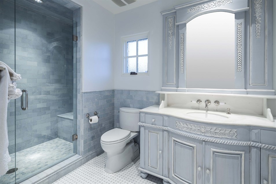 Example of a mid-sized classic kids' blue tile and subway tile marble floor and gray floor alcove shower design in Phoenix with a drop-in sink, furniture-like cabinets, distressed cabinets, marble countertops, a two-piece toilet, blue walls and a hinged shower door