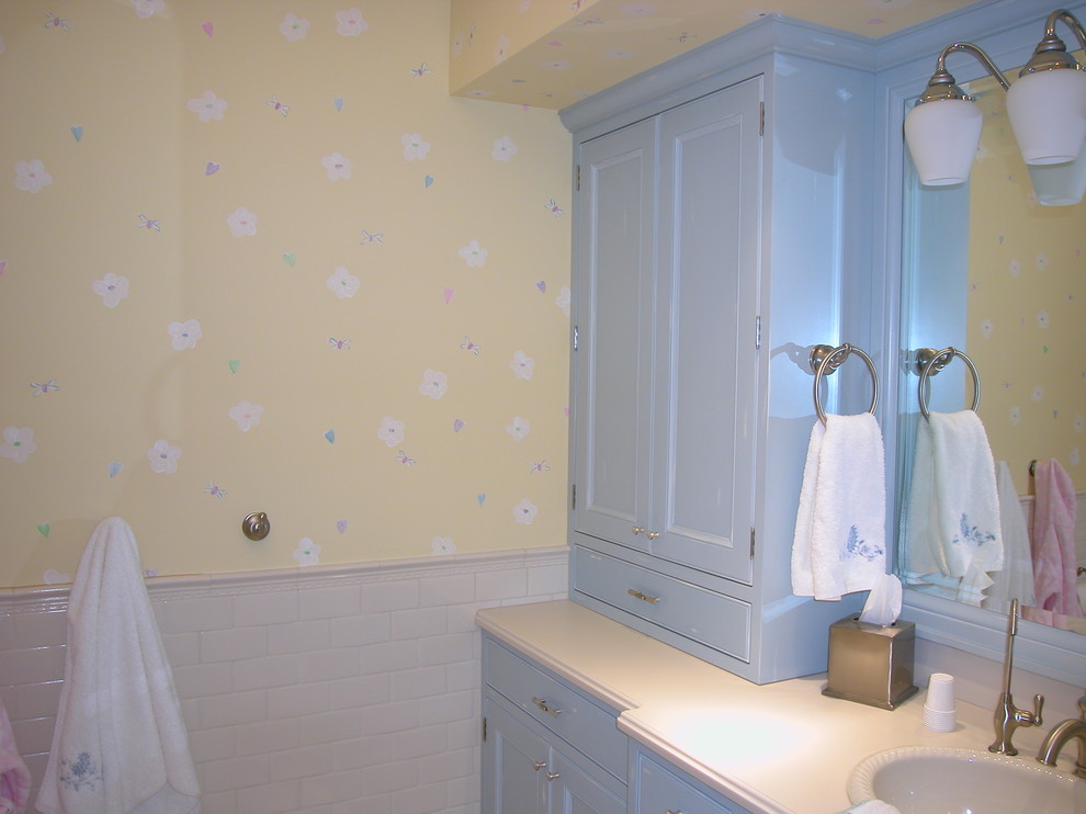 Example of a mid-sized classic kids' white tile and subway tile bathroom design in Grand Rapids with recessed-panel cabinets, blue cabinets, yellow walls, an undermount sink and quartzite countertops