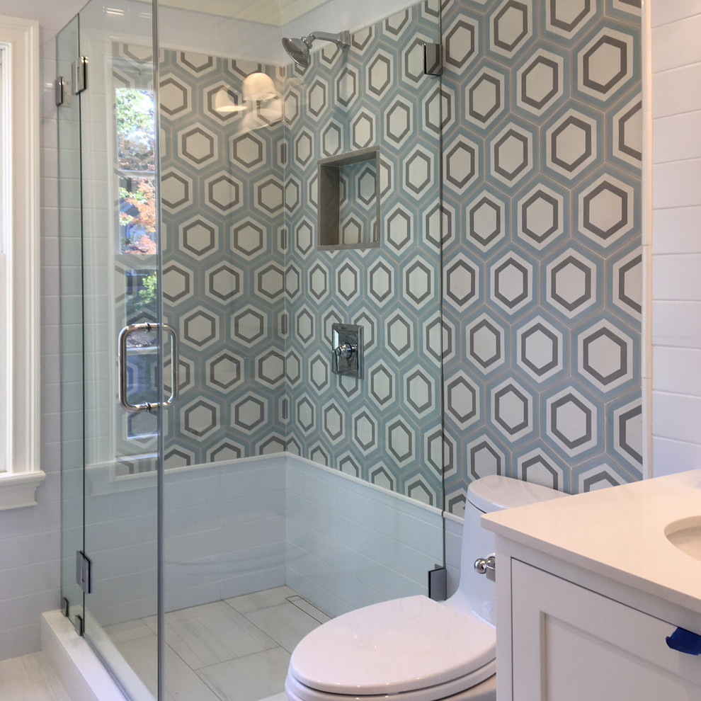 Example of a small trendy 3/4 white tile and subway tile marble floor and white floor corner shower design in New York with beaded inset cabinets, white cabinets, a one-piece toilet, blue walls, an undermount sink, quartzite countertops, a hinged shower door and white countertops