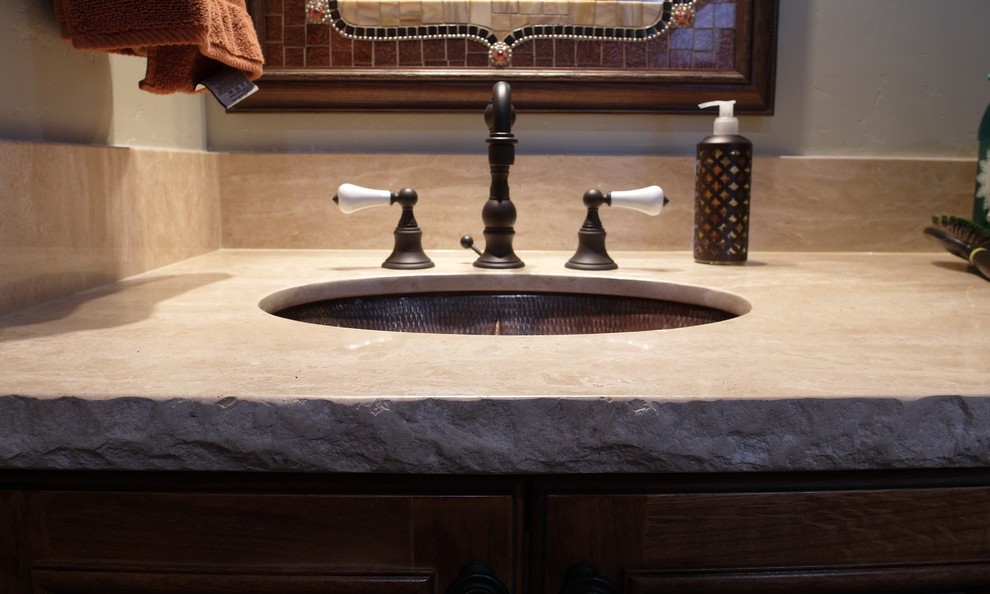 Immagine di una stanza da bagno con doccia rustica di medie dimensioni con ante con riquadro incassato, ante in legno bruno, WC a due pezzi, pareti grigie e lavabo sottopiano