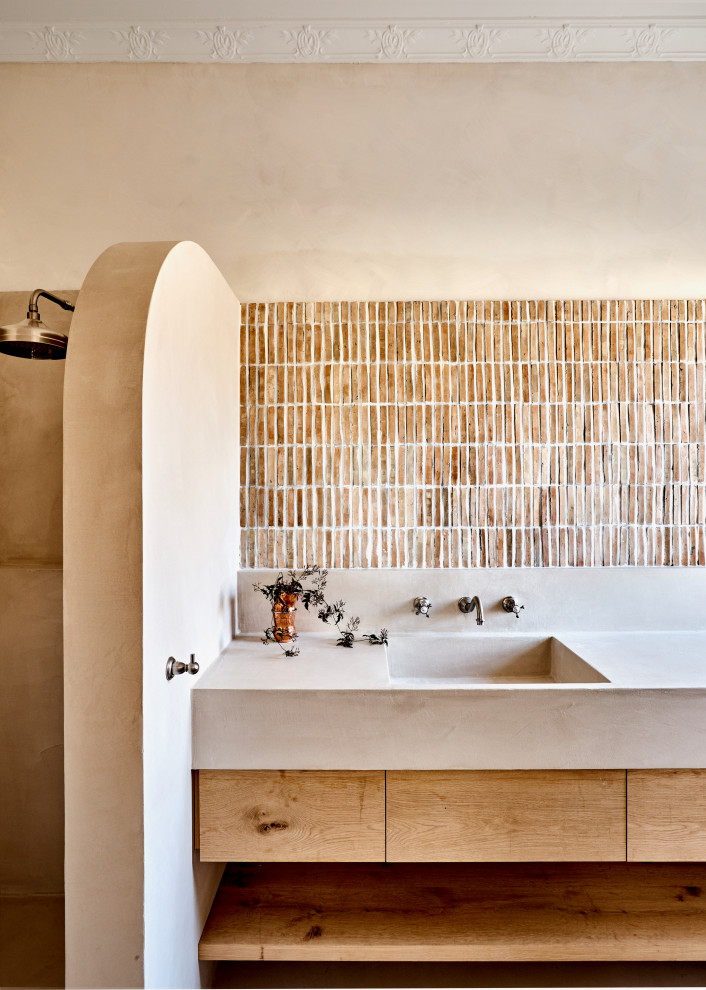 Idee per una stanza da bagno con doccia mediterranea di medie dimensioni con ante lisce, ante in legno chiaro, doccia aperta, piastrelle beige, piastrelle marroni, pareti beige, lavabo integrato, top grigio, un lavabo e mobile bagno incassato