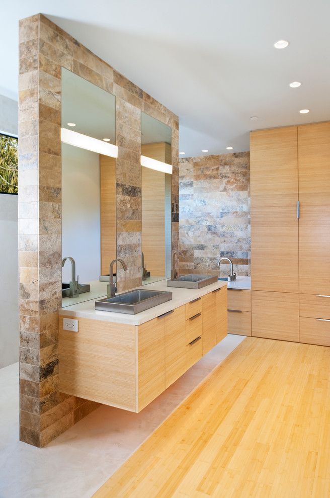 Medium sized modern ensuite bathroom in Seattle with a vessel sink, flat-panel cabinets, light wood cabinets, multi-coloured tiles, stone tiles, grey walls and bamboo flooring.