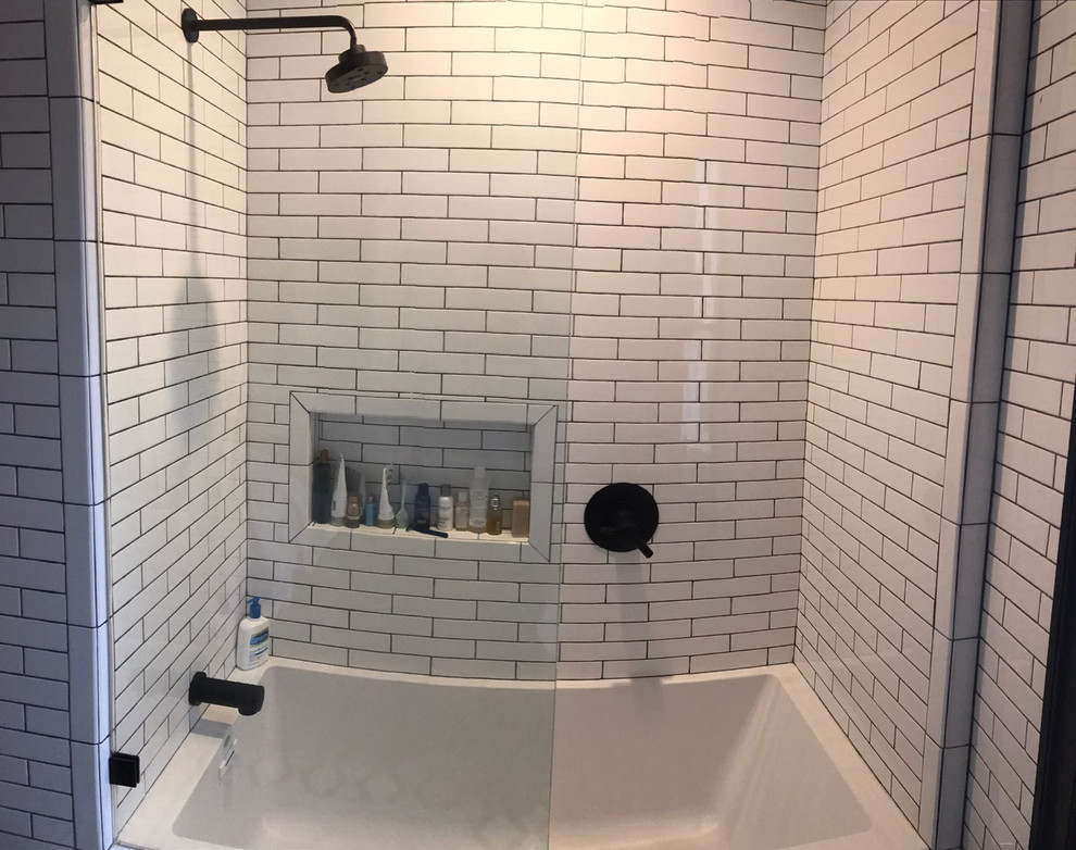 Inspiration for a mid-sized modern 3/4 white tile and subway tile marble floor and multicolored floor bathroom remodel in DC Metro with shaker cabinets, black cabinets, a one-piece toilet, white walls, an undermount sink, marble countertops, a hinged shower door and white countertops