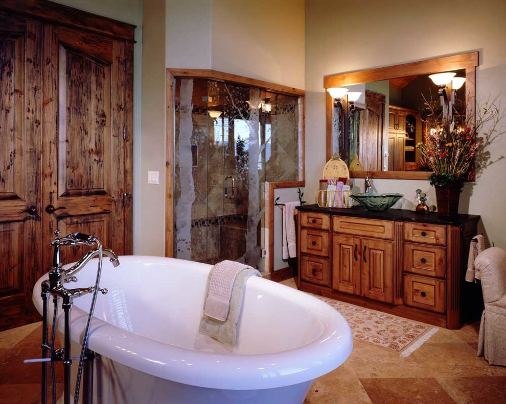 Medium sized rustic ensuite bathroom in Denver with freestanding cabinets, light wood cabinets, a freestanding bath, an alcove shower, beige walls, ceramic flooring, a vessel sink and a hinged door.
