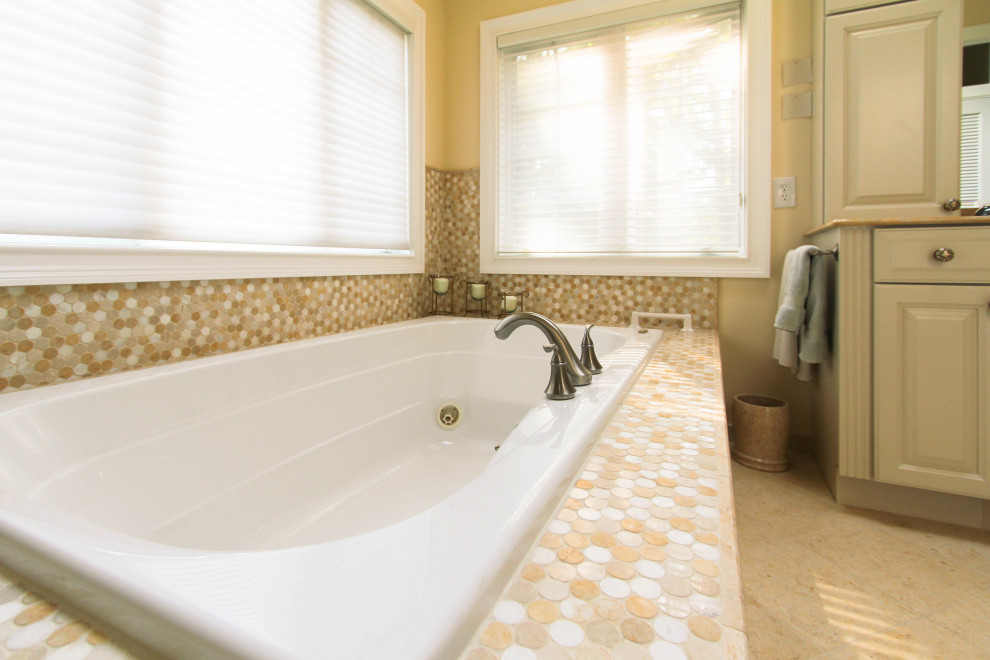 Bathroom - large eclectic master multicolored tile and mosaic tile porcelain tile and beige floor bathroom idea in Philadelphia with beaded inset cabinets, white cabinets, a two-piece toilet, beige walls, an undermount sink, granite countertops, a hinged shower door and beige countertops