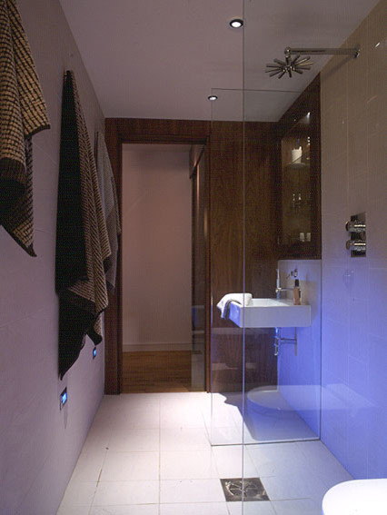 Inspiration for a small contemporary ensuite bathroom in Edinburgh with a wall-mounted sink, a walk-in shower, a wall mounted toilet, white tiles, porcelain tiles, white walls and porcelain flooring.