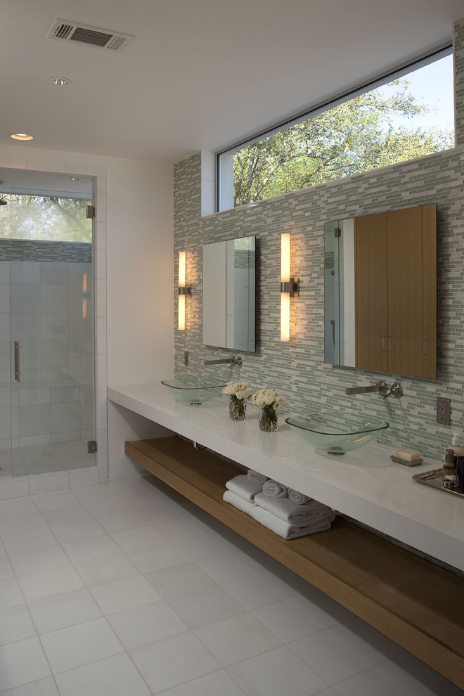 Photo of a large contemporary ensuite bathroom in Austin with a vessel sink, an alcove shower, white walls, ceramic flooring, open cabinets, medium wood cabinets, green tiles, white tiles, glass tiles, engineered stone worktops and feature lighting.