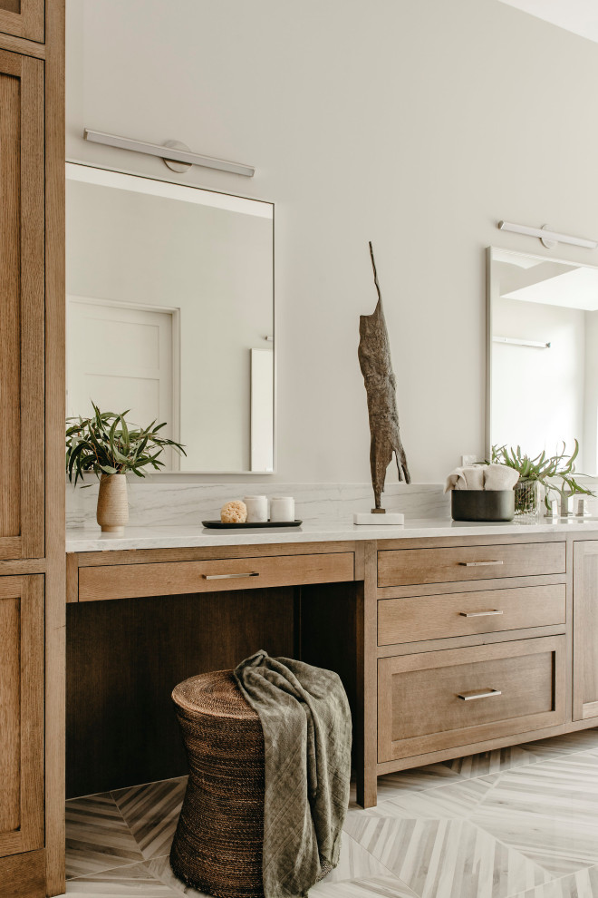 This is an example of a large contemporary ensuite bathroom in Austin with flat-panel cabinets, medium wood cabinets, grey walls, porcelain flooring, a submerged sink, grey floors, white worktops, double sinks and a built in vanity unit.